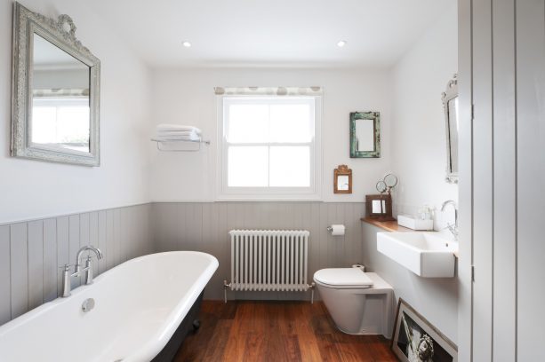 grey and white bathroom with hardwood floor