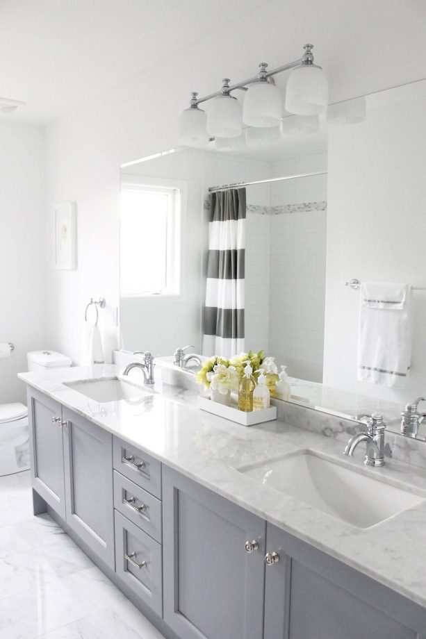 grey and white bathroom with stripes shower curtain