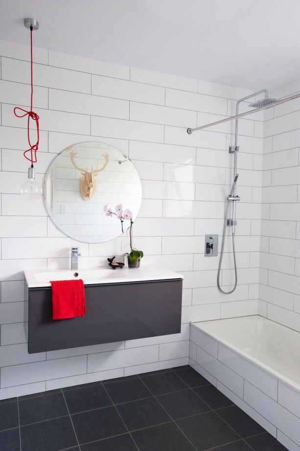 grey and white bathroom with subway tile wall