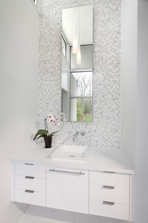 grey and white bathroom with tall mirror