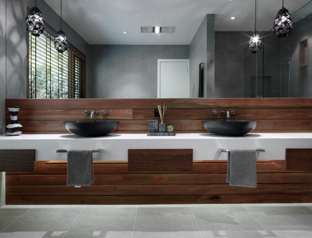 grey and white bathroom with wood panels for the sink area