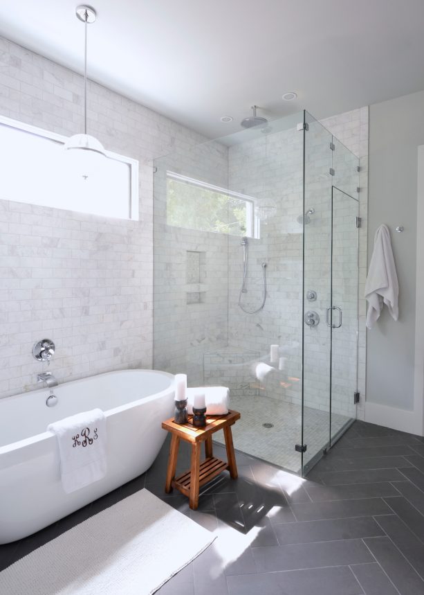 grey and white bathroom with wooden stool