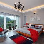grey bedroom with accentuating red decorations