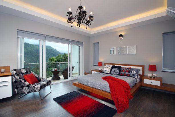 grey bedroom with accentuating red decorations