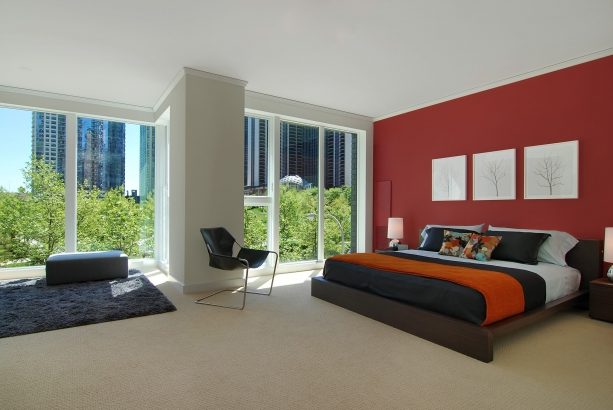 grey bedroom with deep red accent wall