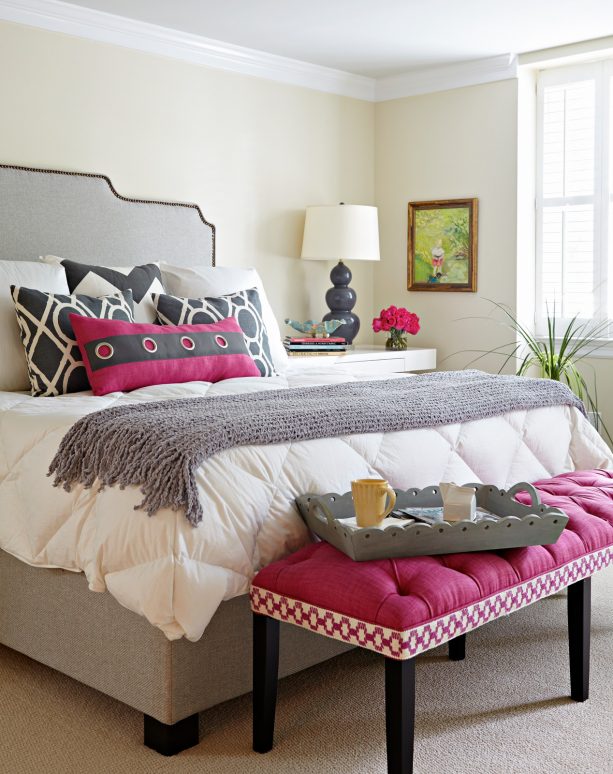 grey bedroom with pink bench