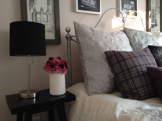 grey bedroom with pink flowers in a vase