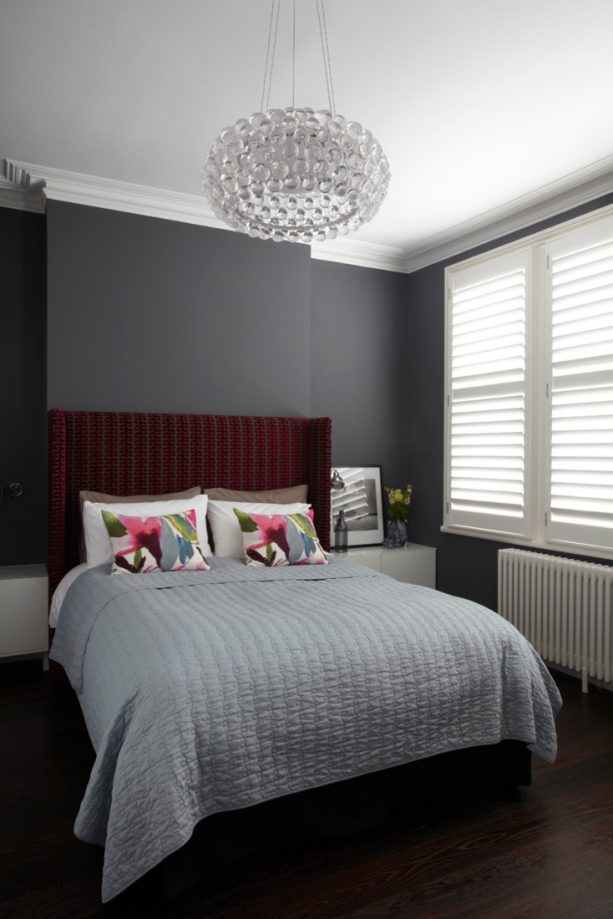 grey bedroom with stripes dark red headboard