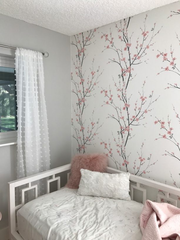 pink and grey bedroom with cherry blossom wallpaper