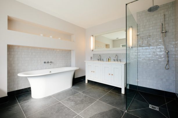 white bathroom with classic-looking grey stone tile flooring