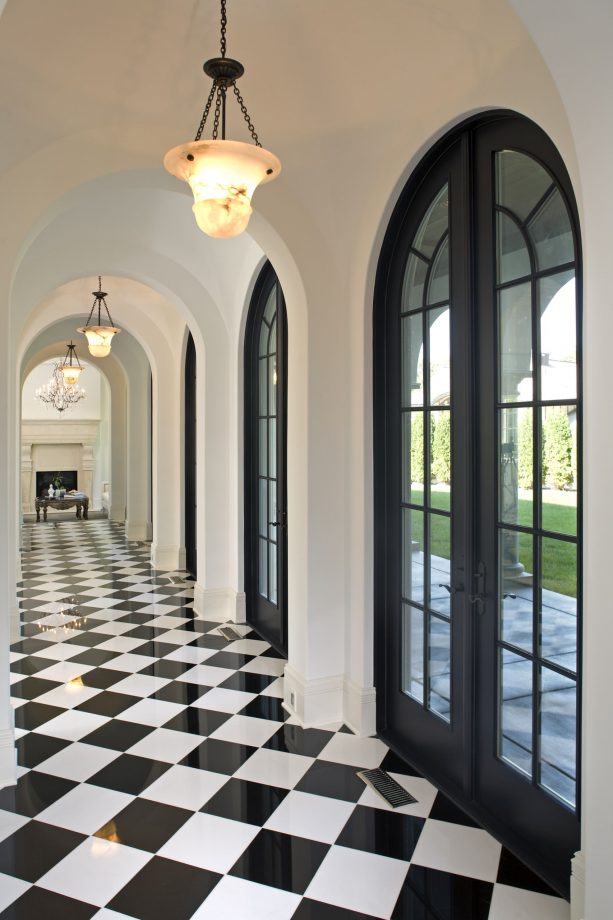 white hallway with black French doors