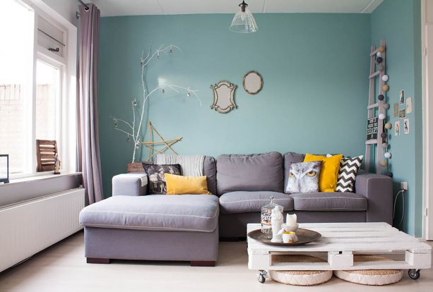 grey and mustard living room with mint accent wall