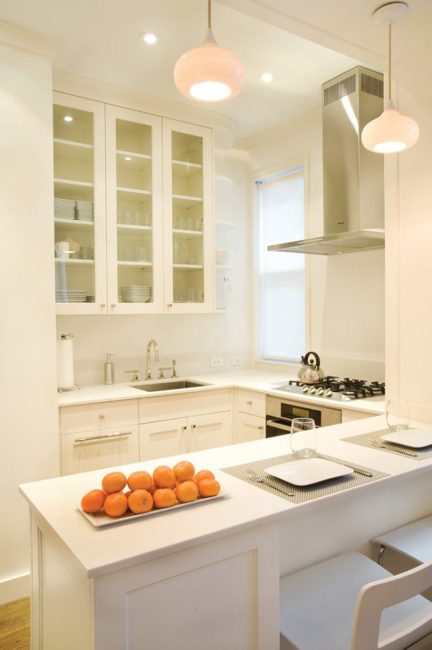 white shaker cabinets paired with kitchen peninsula for a small open kitchen