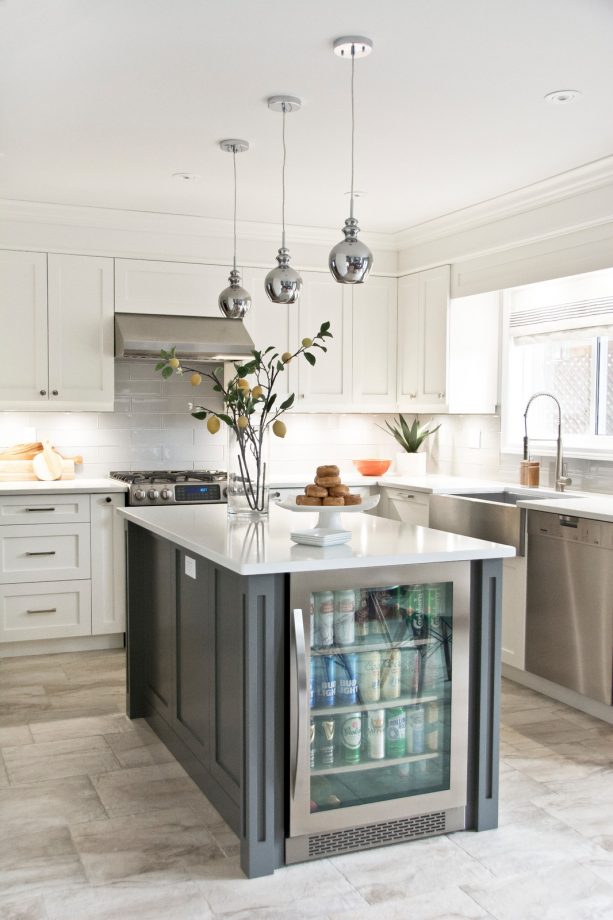 white shaker cabinets paired with stainless-steel appliances and range hood
