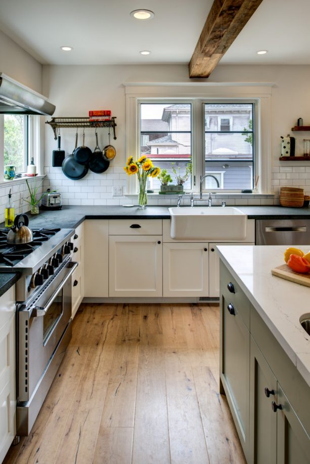 white shaker kitchen cabinets with black countertops