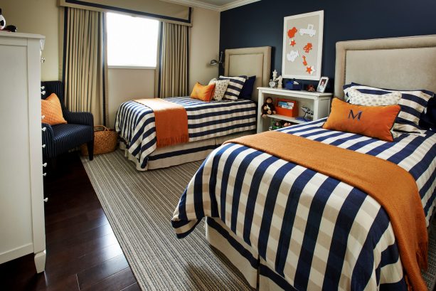 a navy blue bedroom with orange accents