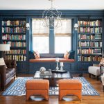 navy blue living room with orange ottomans and window seat