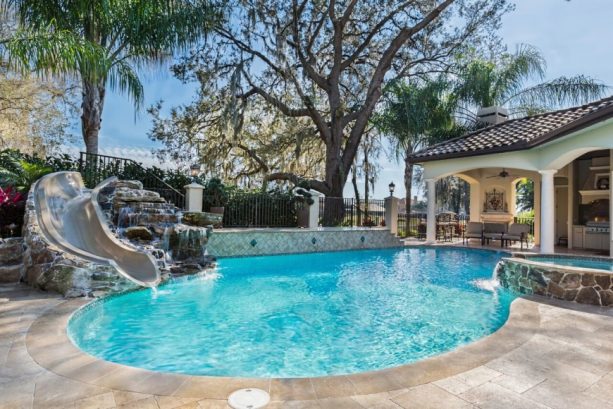 small custom shape inground pool with water slide