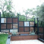 rusty corrugated metal fence with vertical and horizontal design