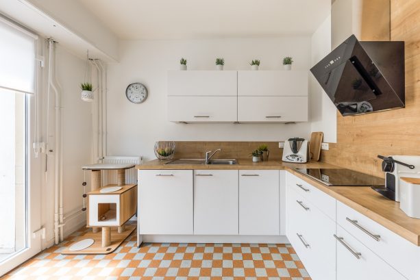 airy and bright white kitchen with brown wooden backsplash and countertops