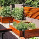 fencing from cinder block and wood with compatible planters