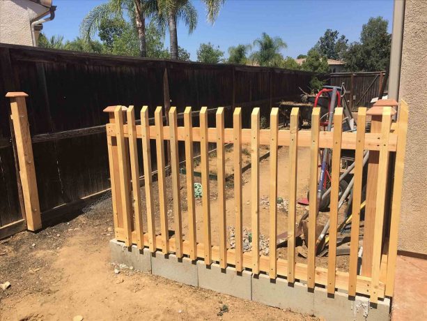 wood fencing with cinder block as the base