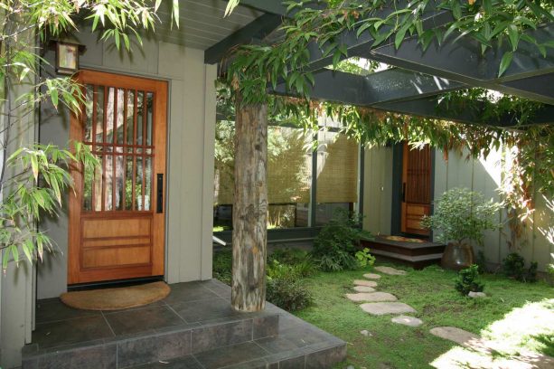 Asian-style entry with three rolled-up bamboo blinds