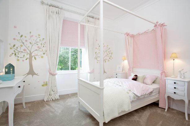 elegant white curtains with tiers and pink shade to treat a short wide kids bedroom window