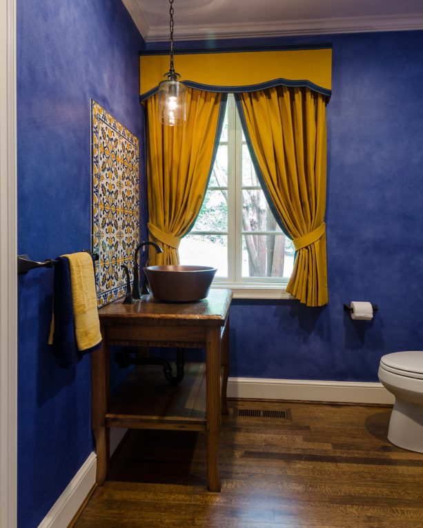 vibrant blue walls and yellow curtains combo in a Mediterranean bathroom