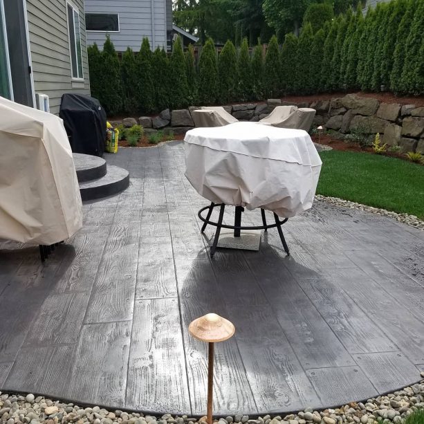 a beautiful patio with dark concrete wood floor