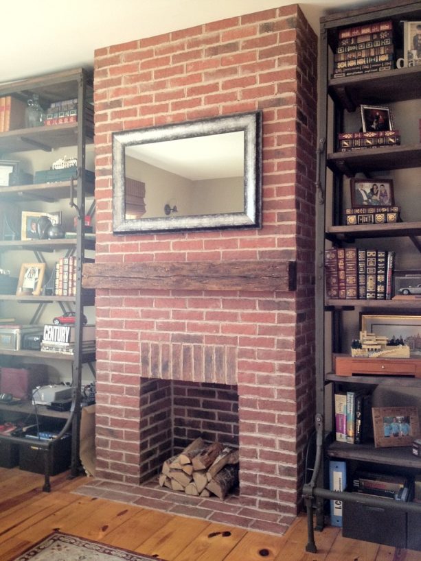 a fireplace covered in thin brick tiles in a traditional family room