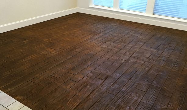 an example of stamped concrete wood floor in basement area