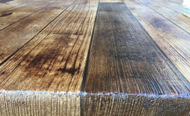 concrete floor gets a wooden look by applying broom finish method