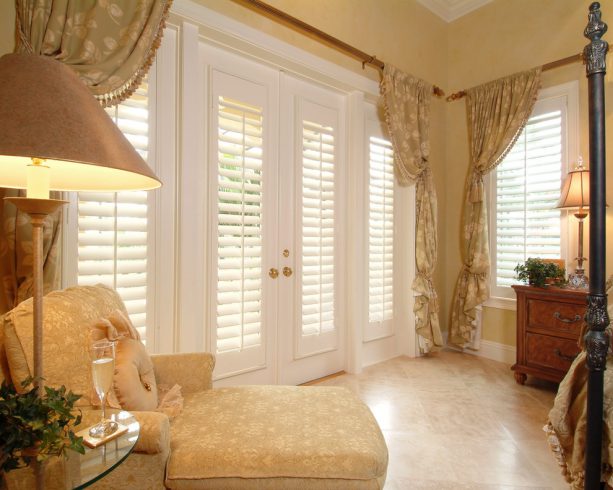 plantation shutters as an elegant detailing of a traditional bedroom
