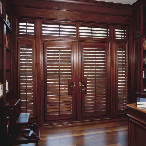 plantation shutters in custom stain to cover brown French doors