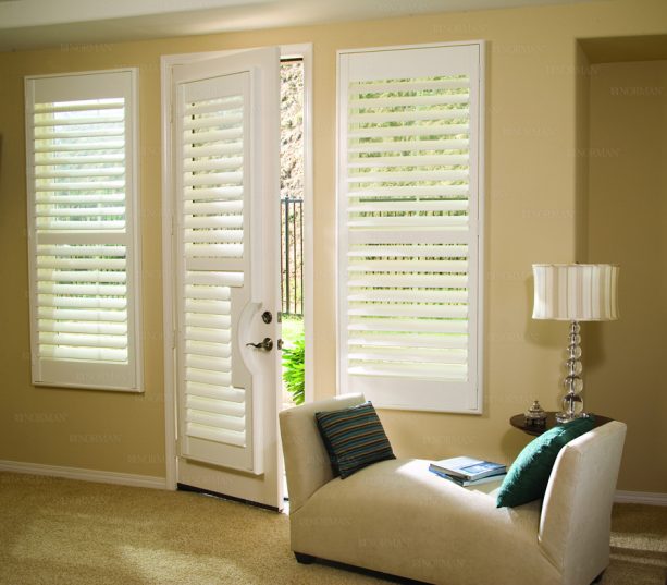 white plantation shutters covering a single French door