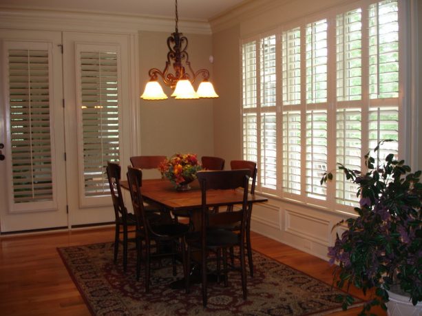 white plantation shutters that cover only the glass parts of the French doors