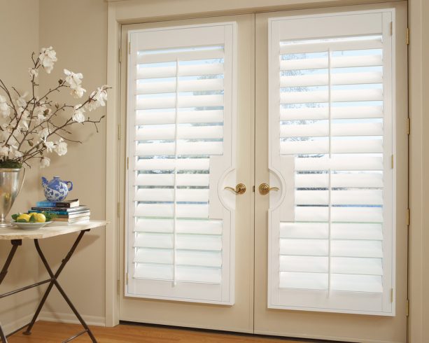 white vinyl plantation shutters on a warm white French doors