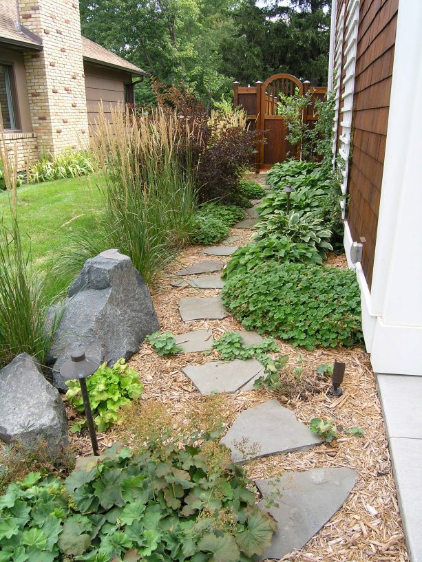 pathway landscape from wood chips mulch and stepping stones