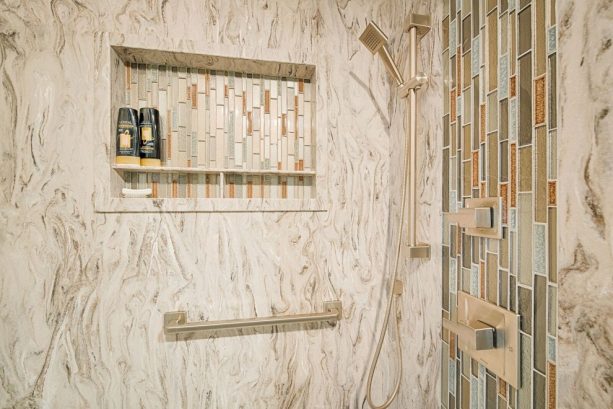 solid surface paired with mosaic tile in shower wall design