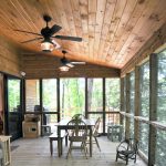 a rustic porch with tongue and groove ceiling from stained knotty material