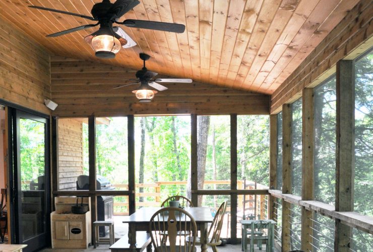 a rustic porch with tongue and groove ceiling from stained knotty material
