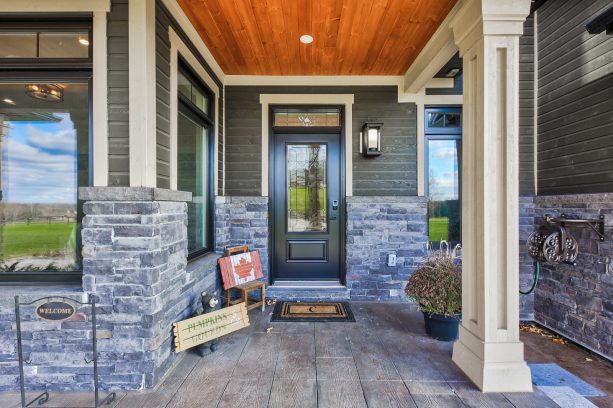 a small front porch with tongue and groove ceiling