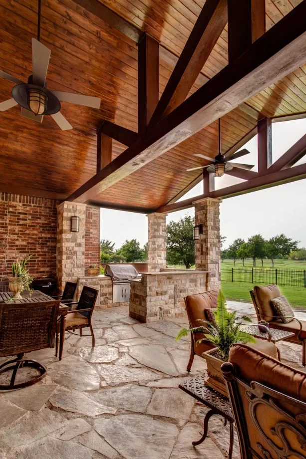 a traditional porch with stained pine tongue and groove ceiling