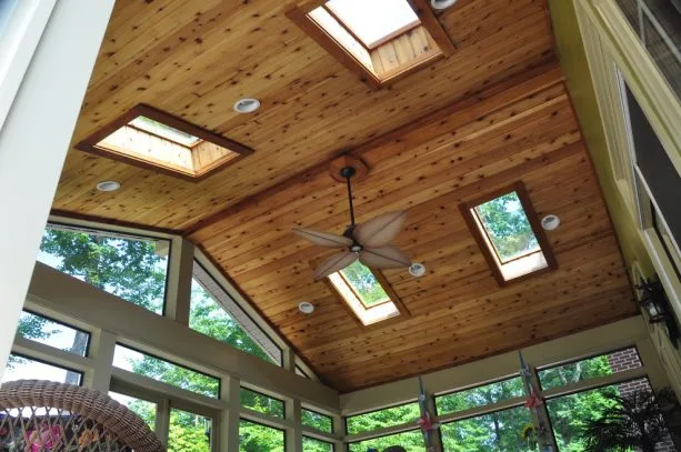 a traditional porch with the combination of glass panels and T&G ceiling from stained cedar material