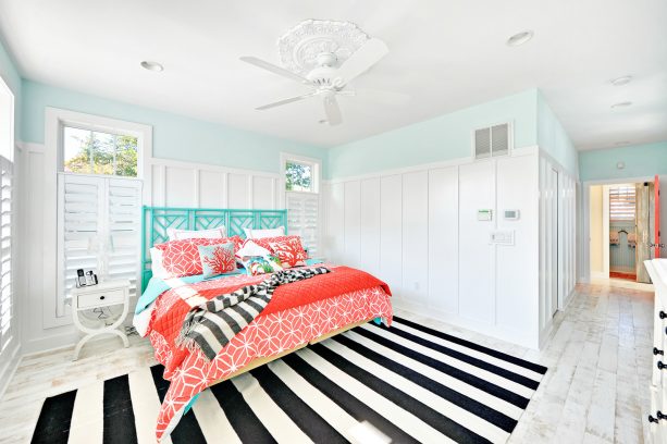 a turquoise bed with bedding sets in coral tones