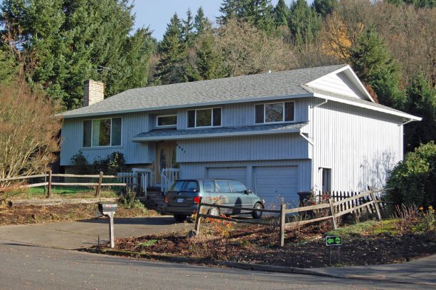 the old split-level house looks messy and uninviting