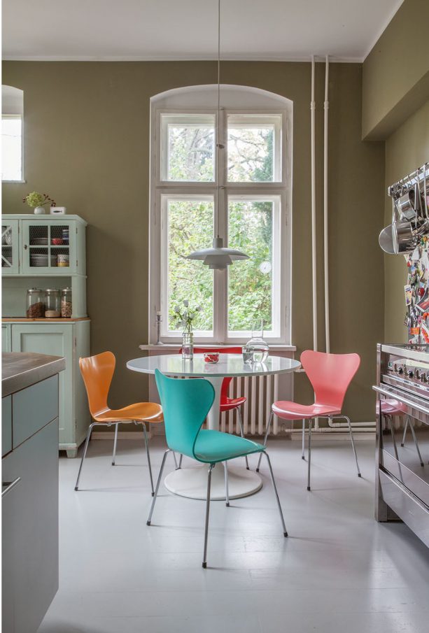 turquoise and tangerine chairs in a contemporary dining room