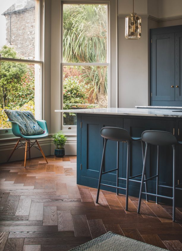 turquoise chair and dark blue island in a contemporary kitchen