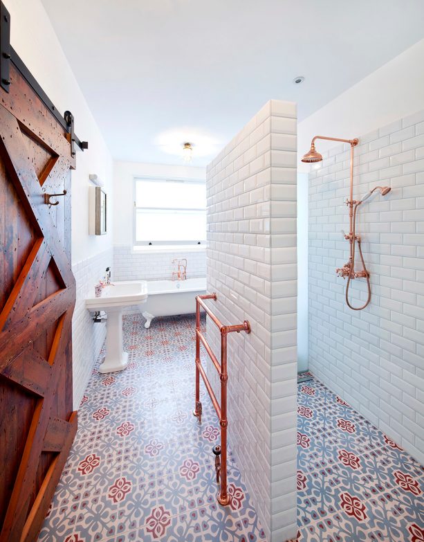 a contemporary bathroom with bulky barn door